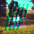 Two people sitting on a bench in a park with a colorful overlay effect.