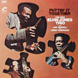 Album cover of 'Puttin' It Together' by The New Elvin Jones Trio featuring three musicians holding instruments.