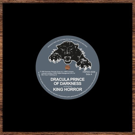 Vinyl record label with a bear illustration and text on a black background