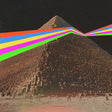 Pyramid with a rainbow beam effect on a dark background