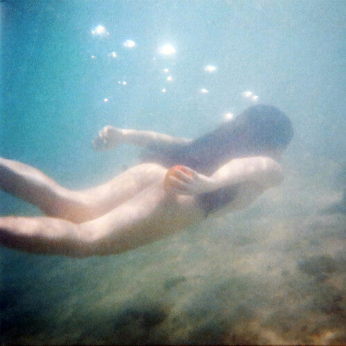 Person swimming underwater with bubbles and a blurred background