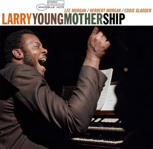 Album cover of 'Motherhip' by Larry Young featuring a musician playing piano with a raised fist.