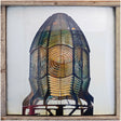 Decorative wall art of a stylized head with a wooden frame