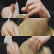 Close-up of hands cleaning a brown leather hat with a white cloth.