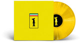 Yellow vinyl record with a black label featuring a silhouette and flag design on a white background