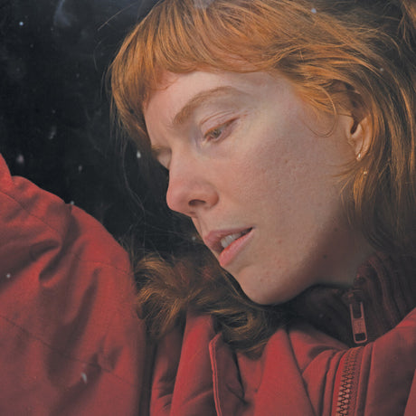 Person wearing a red jacket in a snowy setting