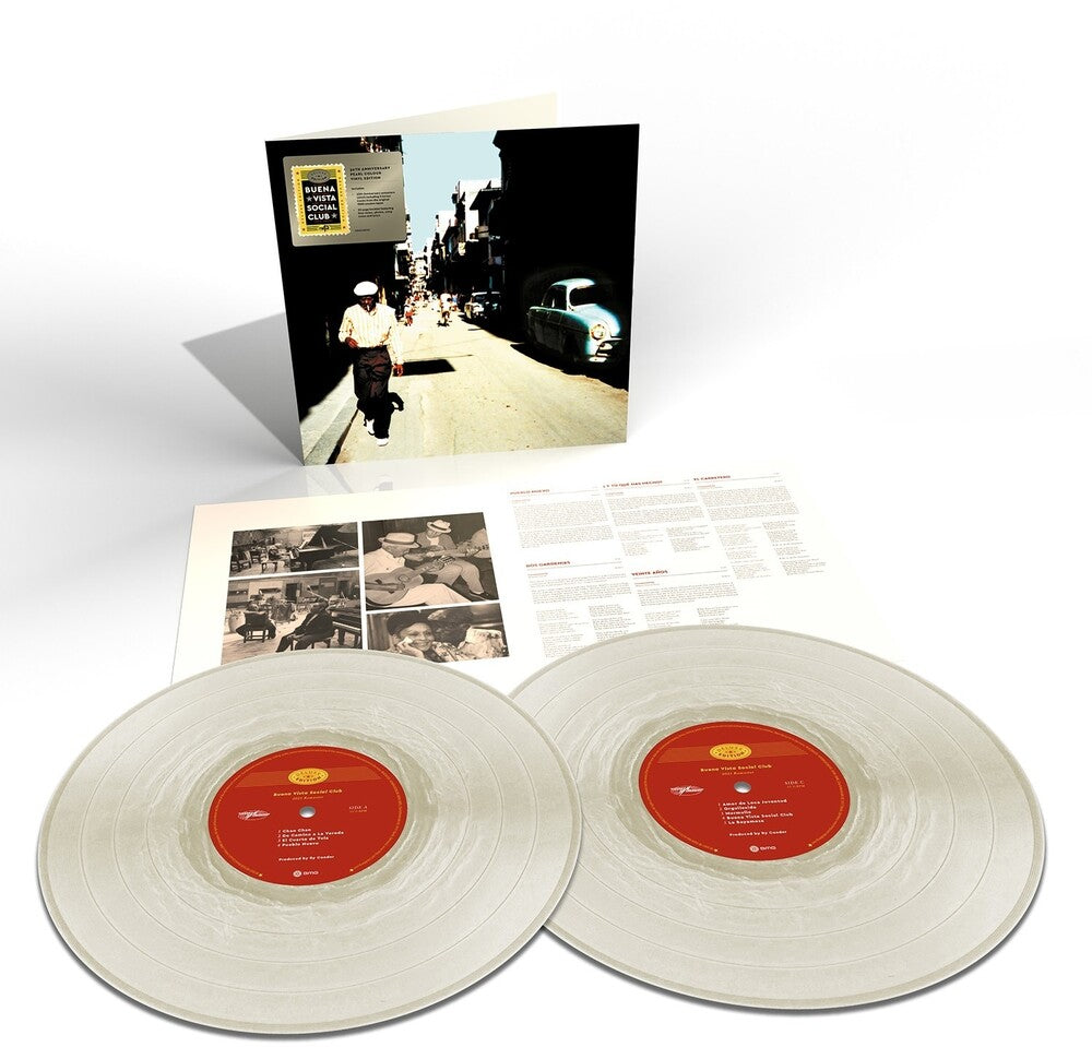 A double vinyl record album set displayed on a white background, including two translucent off-white records with red labels, an open inner sleeve with printed inserts, and the outer cover standing upright showing a vintage street scene.