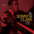 Album cover for 'The Art of the Trio: Sonny Clark' featuring a red-tinted photograph of Sonny Clark at a piano, with large yellow and white title text and small artist names including Paul Chambers, Jymie Merritt, Philly Joe Jones, and Wes Landers.