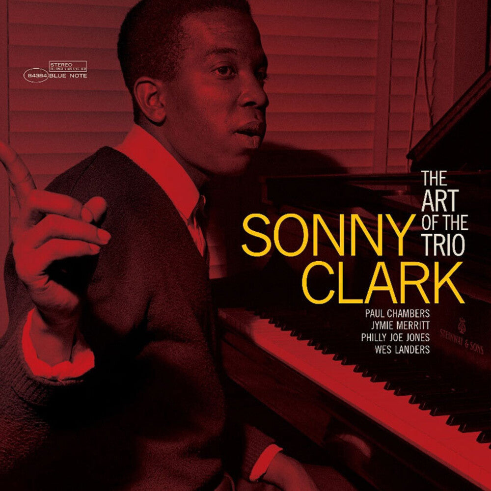 Album cover for 'The Art of the Trio: Sonny Clark' featuring a red-tinted photograph of Sonny Clark at a piano, with large yellow and white title text and small artist names including Paul Chambers, Jymie Merritt, Philly Joe Jones, and Wes Landers.