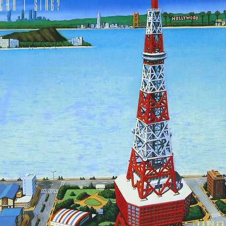 Red and white tower with a cityscape background