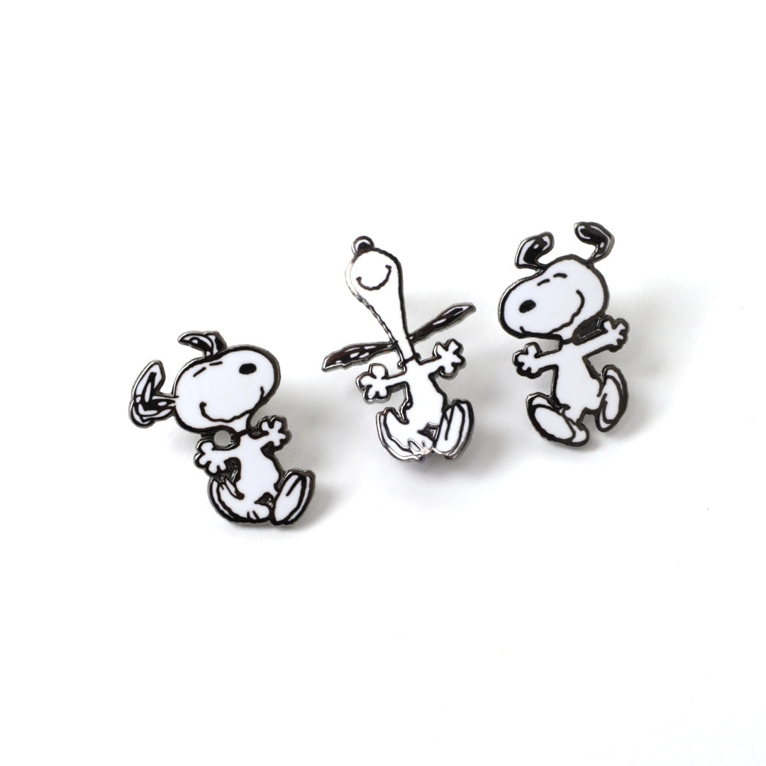 Three black and white dog-shaped earrings on a white background