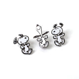 Three black and white dog-shaped earrings on a white background