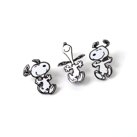 Three black and white dog-shaped earrings on a white background