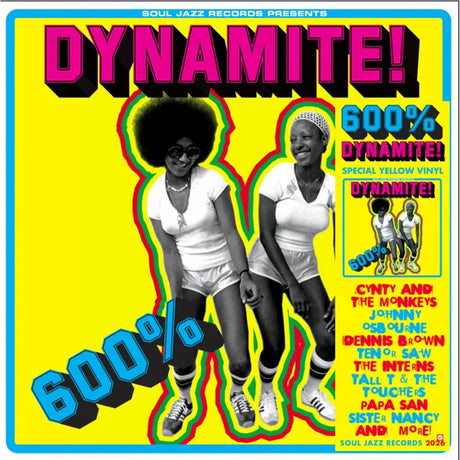 Album cover for 'Dynamite!' featuring two people with a vibrant yellow background.