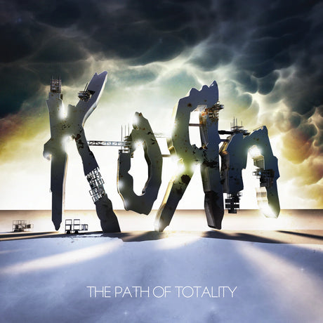Album cover art for 'The Path of Totality' featuring large, stylized metallic letters spelling the artist name or title against a dramatic cloudy sky with bright light rays over a snowy or icy ground.
