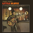 Album cover featuring a person playing guitar in a room with wood paneling and a television.