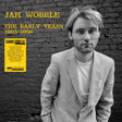 Album cover with a person leaning against a brick wall, featuring text about Jah Wobble's 'The Early Years 1983-1986'.