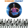 Album cover with a person in a purple tank top and hat, surrounded by text and building silhouettes.