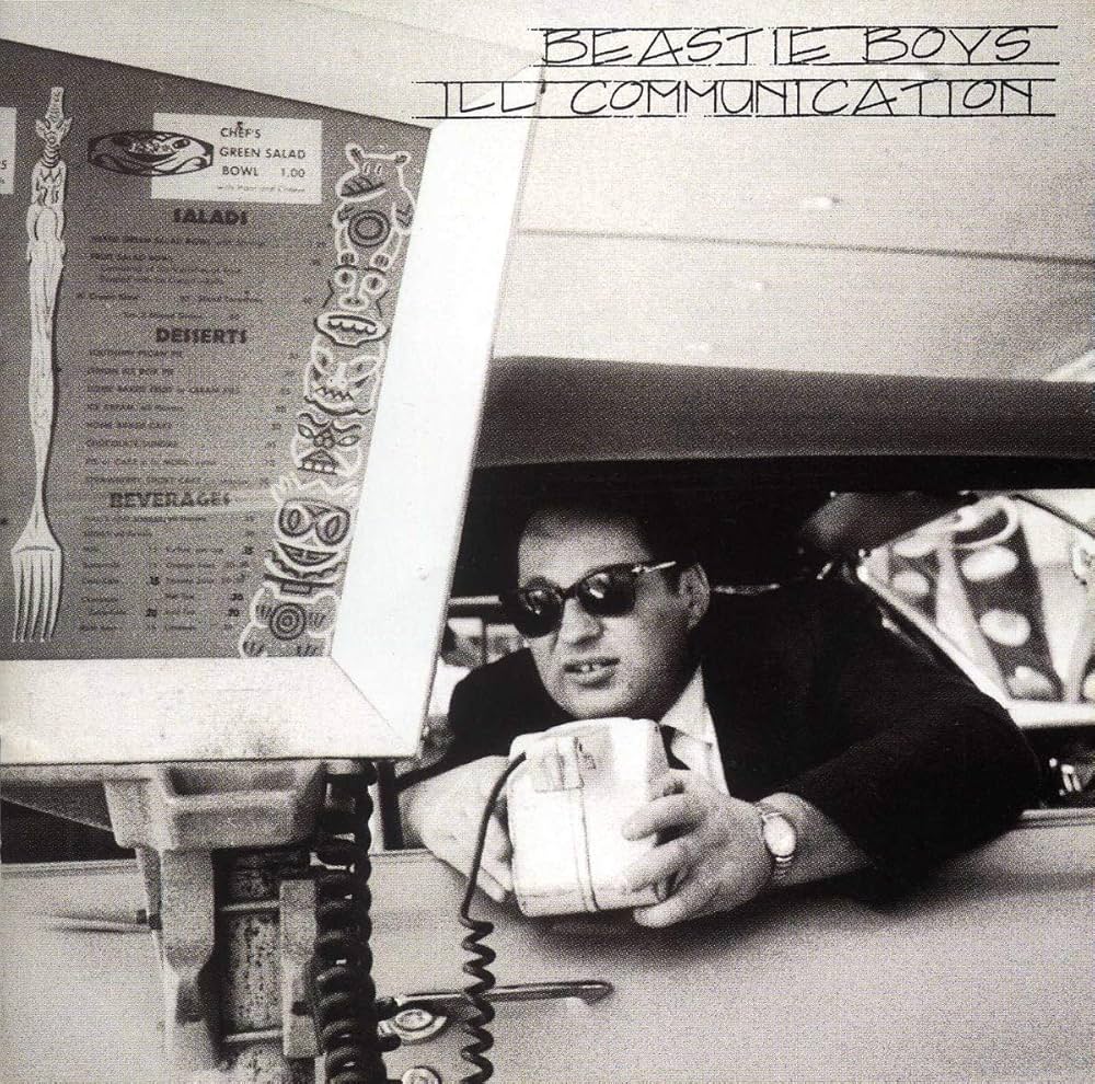 Album cover with a person holding a cup, menu, and 'Beastie Boys Ill Communication' text.
