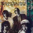 Album cover of 'Traveling Wilburys' with four band members and a vintage design.