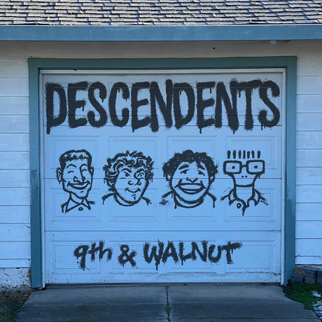 Garage door with 'DESCENDENTS 9th & WALNUT' spray-painted on it.