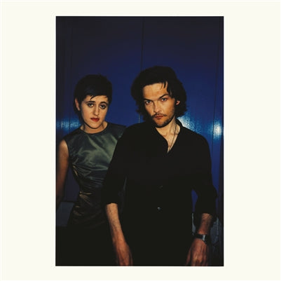 Two people standing side by side against a dark background