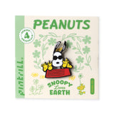 Peanuts-themed pin with Snoopy on a decorative card