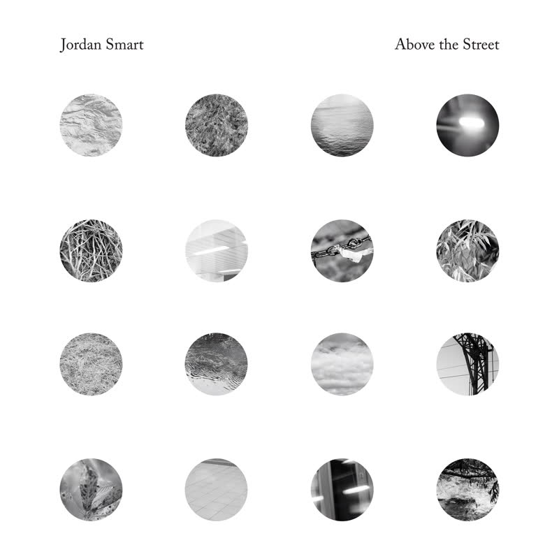 Album cover with black and white circular patterns and text 'Jordan Smart Above the Street' at the top.