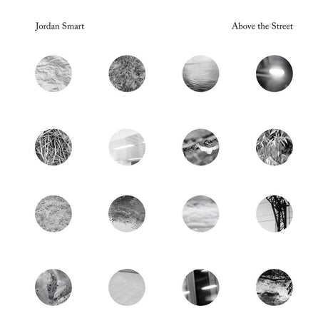 Album cover with black and white circular patterns and text 'Jordan Smart Above the Street' at the top.
