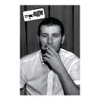 Black and white photo of a man smoking with ' Arctic Monkeys ' logo above