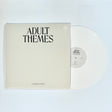 Vinyl record with 'Adult Themes' cover on a white background