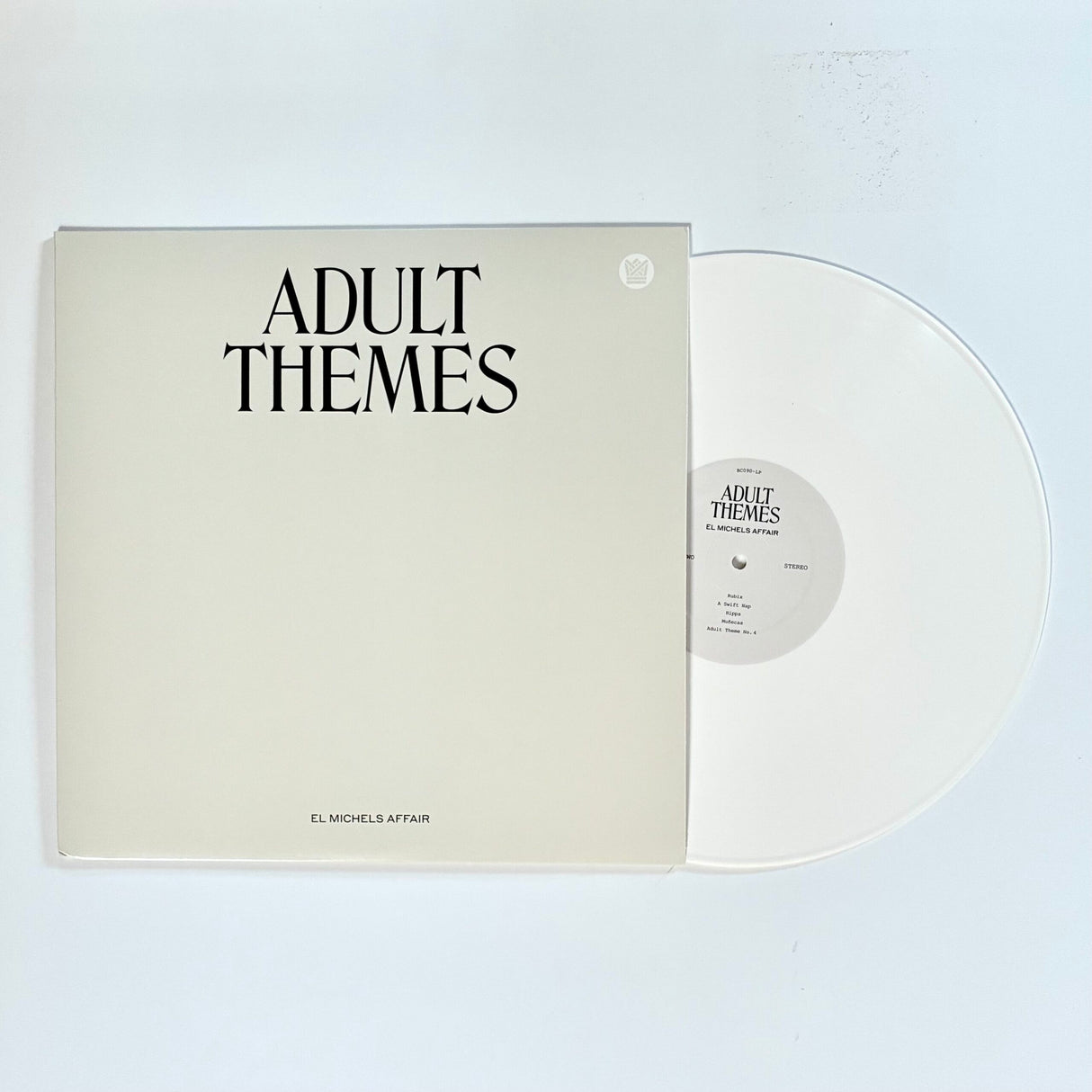 Vinyl record with 'Adult Themes' cover on a white background