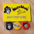 Button pack with 'Nardwuar the Human Serviette' design on a yellow card, displayed on a wooden surface.