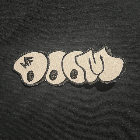 Textured patch with 'MF DOOM' logo on a black background