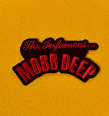 Embroidered patch with 'The Infamous Mobb Deep' text on a yellow background