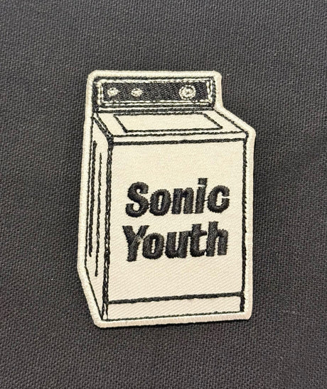 Embroidered patch of a washing machine with 'Sonic Youth' text on a dark background
