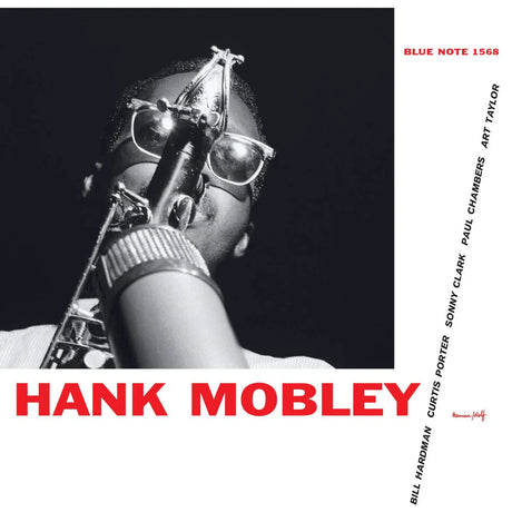 Album cover featuring a saxophone with a person holding it, black and white with red text.