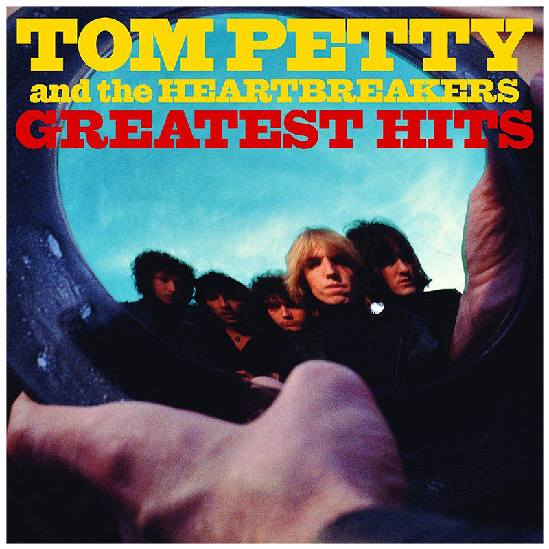 Album cover of 'Greatest Hits' by Tom Petty and the Heartbreakers with band members and a blue sky.