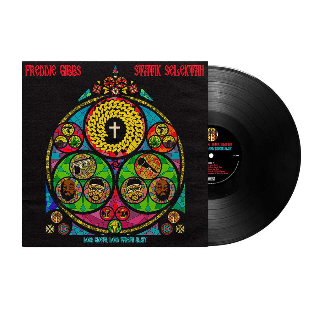 Vinyl record with a colorful cover featuring a central cross and various symbols, on a white background.