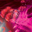 Close-up of a pink flower with 'Open Your Heart' text overlay