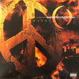 Album cover for A Perfect Circle's 'Emotive' with a peace symbol and cityscape.