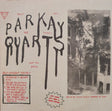 Album cover with stylized text and a black and white photo of a building.