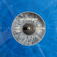Close-up of a translucent blue vinyl record with a gray-and-white center label reading "EARLY HAZE '96 EP" and track listing text.