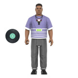 Action figure of a person wearing a purple shirt with a striped design and gray pants, next to a vinyl record on a white background.