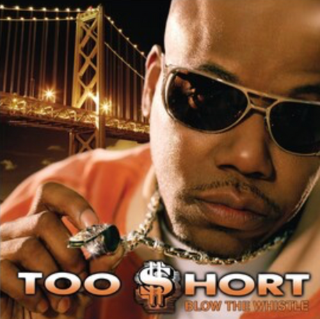 This image features the cover art for the album "Blow The Whistle" by Too $hort. The cover portrays a confident man wearing sunglasses and an orange shirt, holding a whistle in his hand.