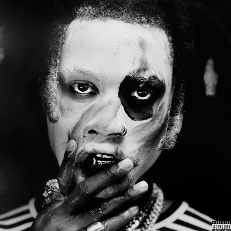 Black and white image of Denzel Curry with a gold paint splatter on his face, indicating a bold and expressive pose for the album cover.