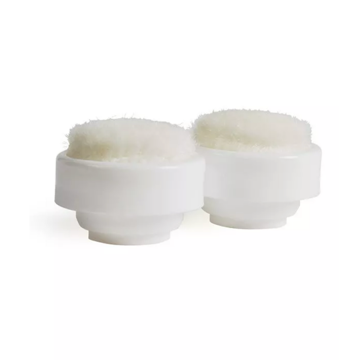 Two white cylindrical containers with fluffy white tops on a white background