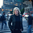 Album cover with a person in a city street setting, featuring the text 'Lucinda Williams World's Gone Wrong'.