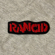 Embroidered patch with 'Iron Maid' text on a gray fabric background