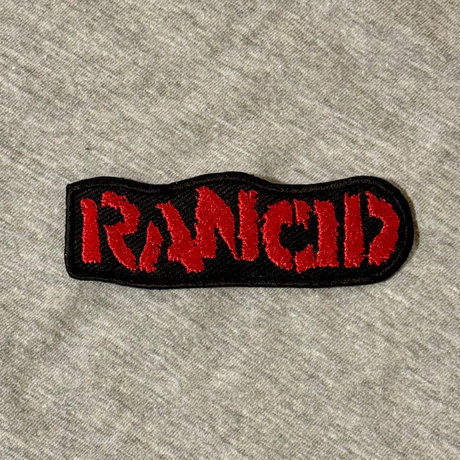 Embroidered patch with 'Iron Maid' text on a gray fabric background